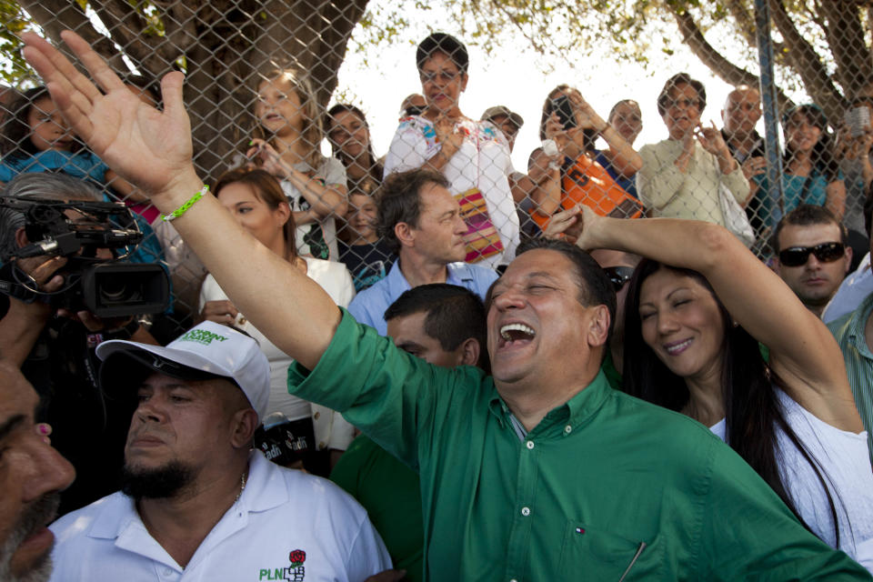 Johnny Araya, presidential candidate for the National Liberation Party, PLN, waves to supporters outside a polling station, after voting in the general election in San Jose, Costa Rica, Sunday, Feb. 2, 2014. The ruling PLN has been beset by infighting and corruption allegations and Araya, now faces three rivals, which experts say could splinter Sunday's vote. Araya, who has been the mayor of the capital of San Jose since 2003, must overcome the discontent over high unemployment during President Laura Chinchilla's government. (AP Photo/Moises Castillo)