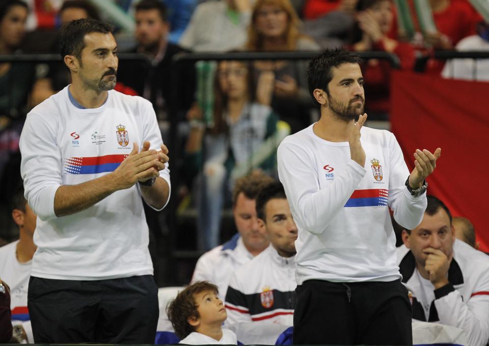 Janko Tipsarevic (right) had to cheer from the sidelines during Serbia's Davis Cup final tie against the Czech Republic last November. Injured, he remains on the sidelines for this weekend's tie against Serbia. (Photo by Srdjan Stevanovic/Getty Images)