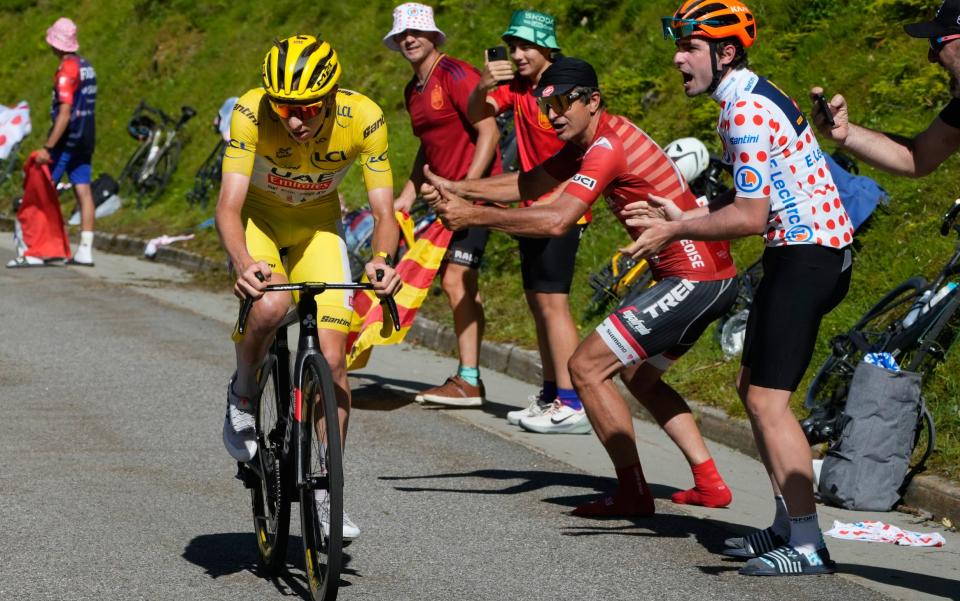 Tadej Pogacar races past spectators