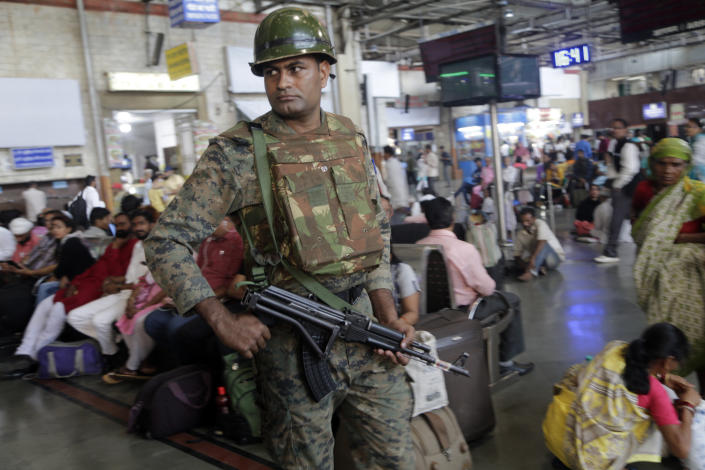 An Indian police officer keeps guard at Chhatrapati Shivaji Terminus railway station in Mumbai, India, Thursday, Feb. 28, 2019. Pakistan's prime minister pledged on Thursday his country would release a captured Indian jetfighter pilot the following day, a move that could help defuse the most-serious confrontation in two decades between the nuclear-armed neighbors over the disputed region of Kashmir. An Indian government official, speaking on condition of anonymity as he was not authorized to speak publicly, warned that even if the pilot is returned home, New Delhi would not hesitate to strike its neighbor first if it feared a similar militant attack was looming. (AP Photo/Rajanish Kakade)