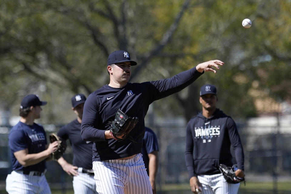 New York Yankees pitcher Carlos Rodon throws to first during a spring training baseball workout Saturday, Feb. 18, 2023, in Tampa, Fla. (AP Photo/David J. Phillip)