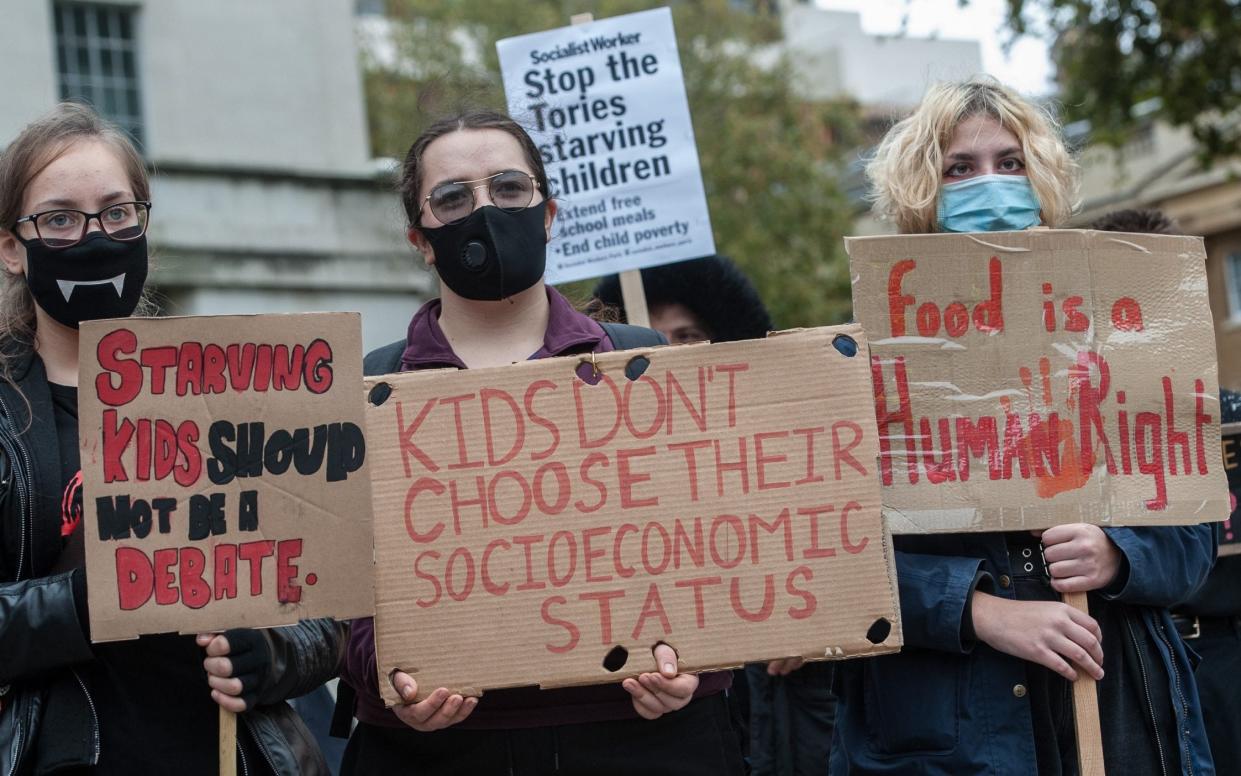 LONDON, ENGLAND - OCTOBER 24: School students and educators protest outside Downing Street against the government decision not to extend free school meals during half term and the Christmas holidays on October 24, 2020 in London, England.  - Guy Smallman/Getty Images