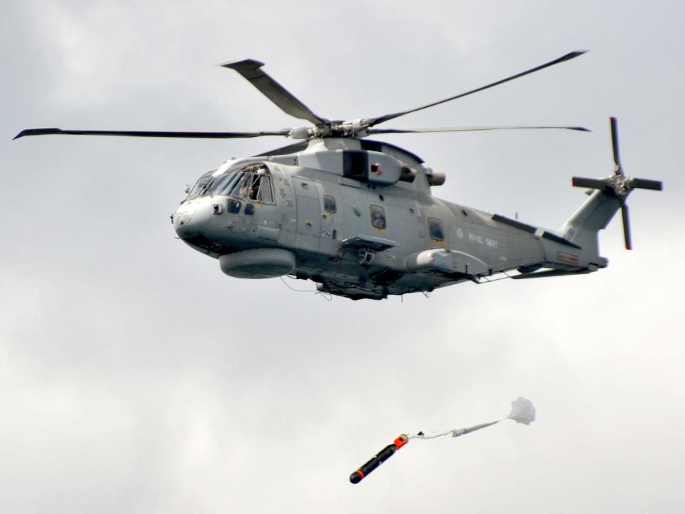 Royal Navy Merlin helicopter launches torpedo