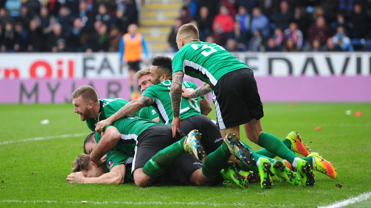 Lincoln City's Sean Raggett celebrates scoring the opening goal with team-mates during The FA Cup Fifth Round match between Burnley and Lincoln City. (Photo by Chris Vaughan - CameraSport via Getty Images)