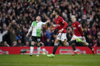 Manchester United's Bruno Fernandes, centre, celebrates after scoring his side's first goal during the English Premier League soccer match between Manchester United and Liverpool at the Old Trafford stadium in Manchester, England, Sunday, April 7, 2024. (AP Photo/Dave Thompson)