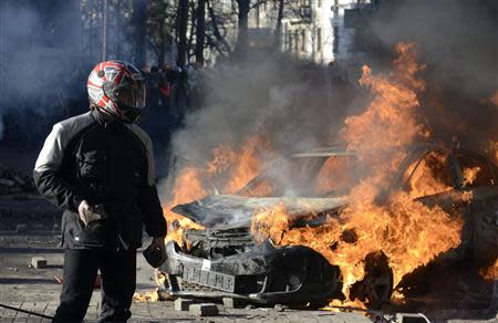 A car burns during clashes between anti-government protesters and Interior Ministry members in Kiev, February 18, 2014. REUTERS/Maks Levin