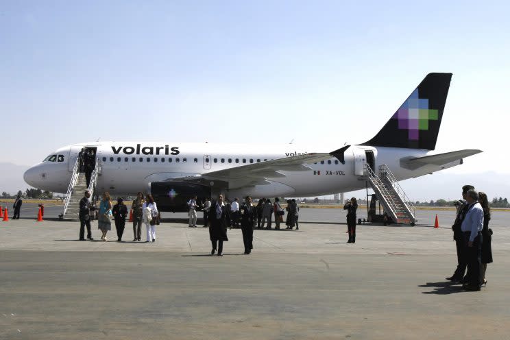 Visitors observe a Volaris airplane at the Ciudad de Toluca airport, Mexico. (AP)