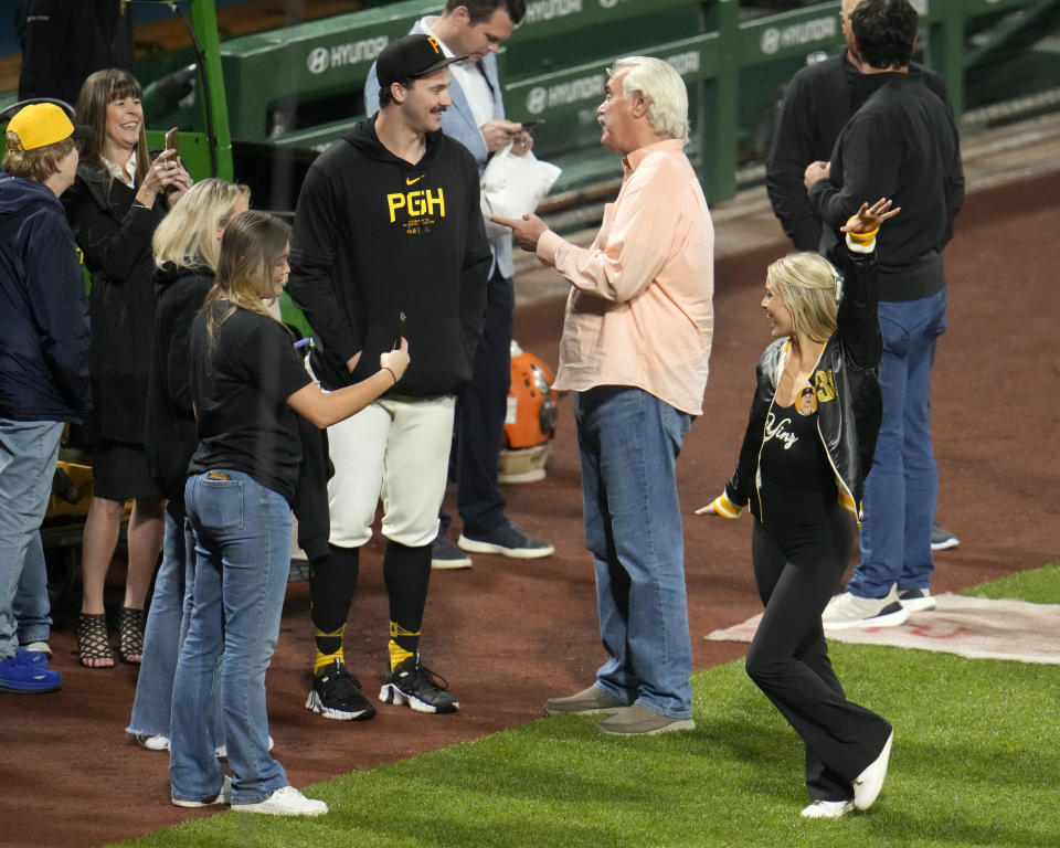 Pittsburgh Pirates starting pitcher Paul Skenes, left center, visits with family and friends, as girlfriend Livvy Dunne, right front, poses for photos after Skenes debut in the majors, against the Chicago Cubs in a baseball game in Pittsburgh, Saturday, May 11, 2024. (AP Photo/Gene J. Puskar)