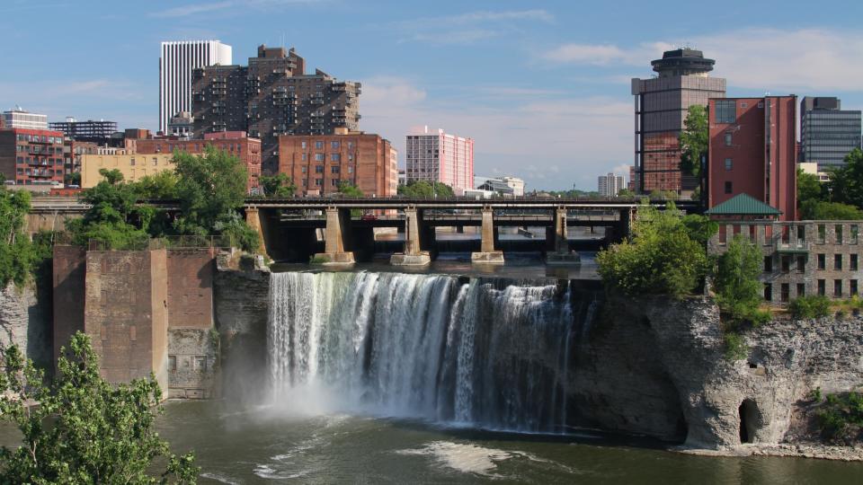photograph of Rochester city with a large waterfall in the center.