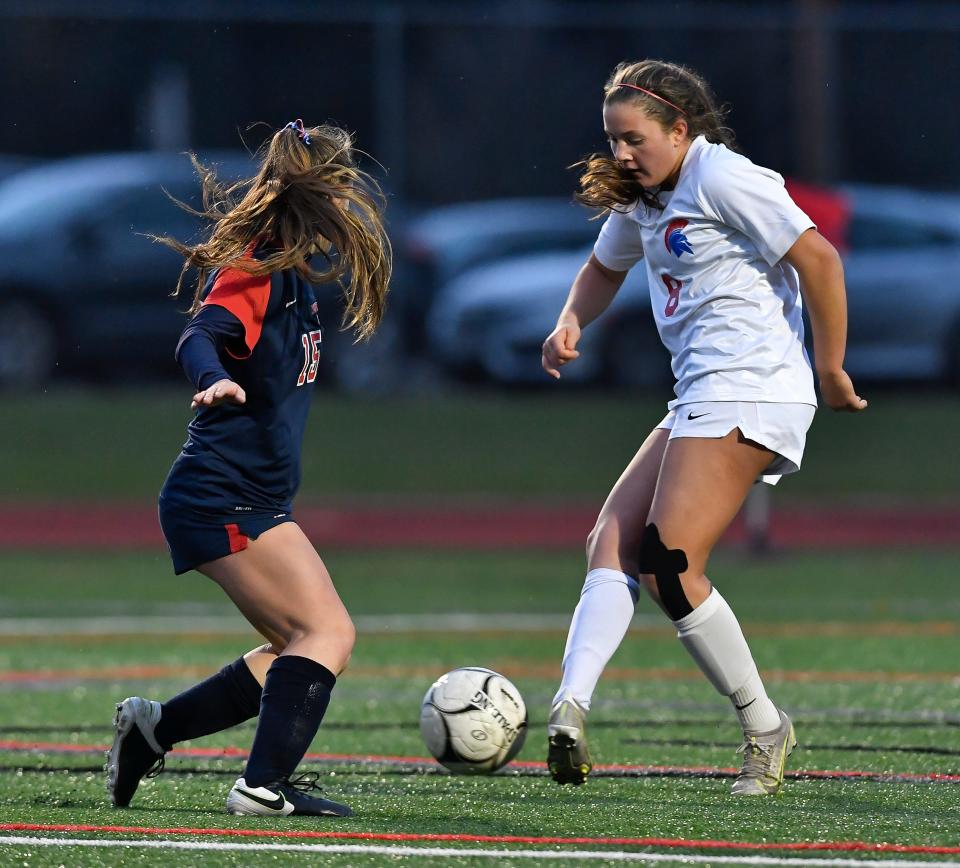 New Hartford's Mia Roberts, right, passes the ball away from South Side's Emma Hospodka during the NYSPHSAA Girls Soccer Championships Class A final in Cortland, N.Y., Sunday, Nov. 14, 2021.
