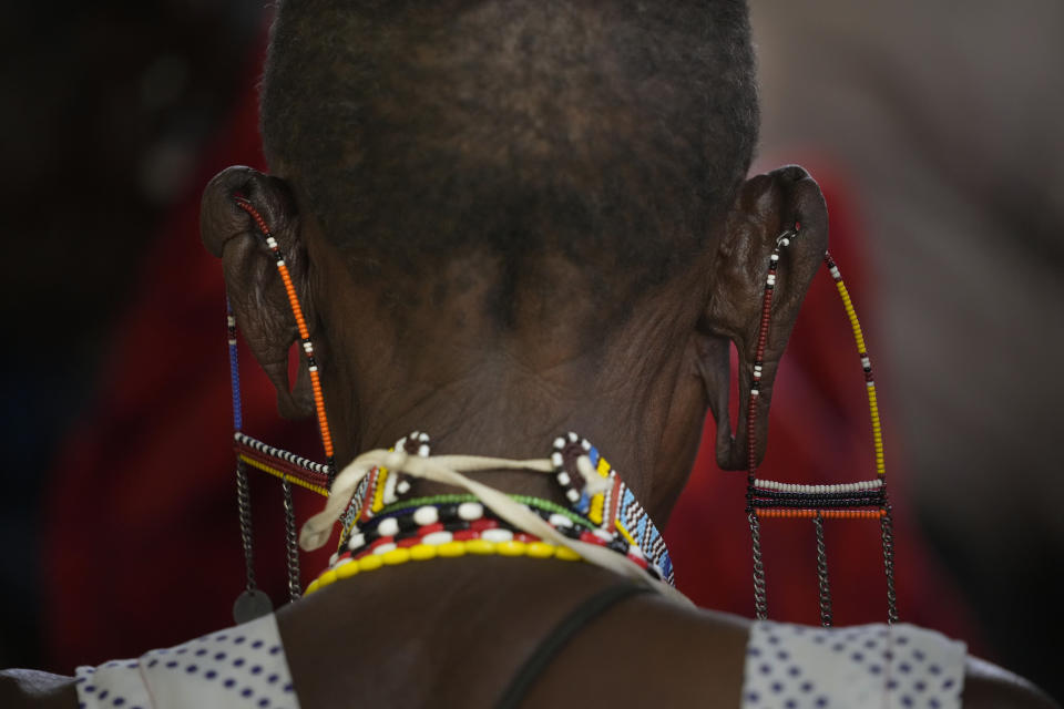 A woman wearing traditional Maasai jewellery lines up to vote at the Oltepesi Primary School, Kajiado County in Nairobi, Kenya, Tuesday Aug. 9, 2022. Kenyans are voting to choose between opposition leader Raila Odinga and Deputy President William Ruto to succeed President Uhuru Kenyatta after a decade in power. (AP Photo/Ben Curtis)