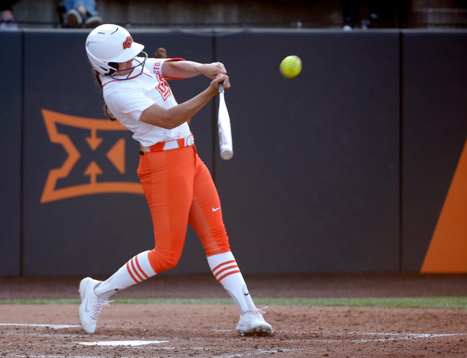 Oklahoma State's Chyenne Factor (9) hits a home run in the fourth inning during the college softball game between the Oklahoma State Cowgirls and the Iowa State Cyclones at Cowgirl Stadium in Stillwater, Okla., Friday, April, 14, 2023. 