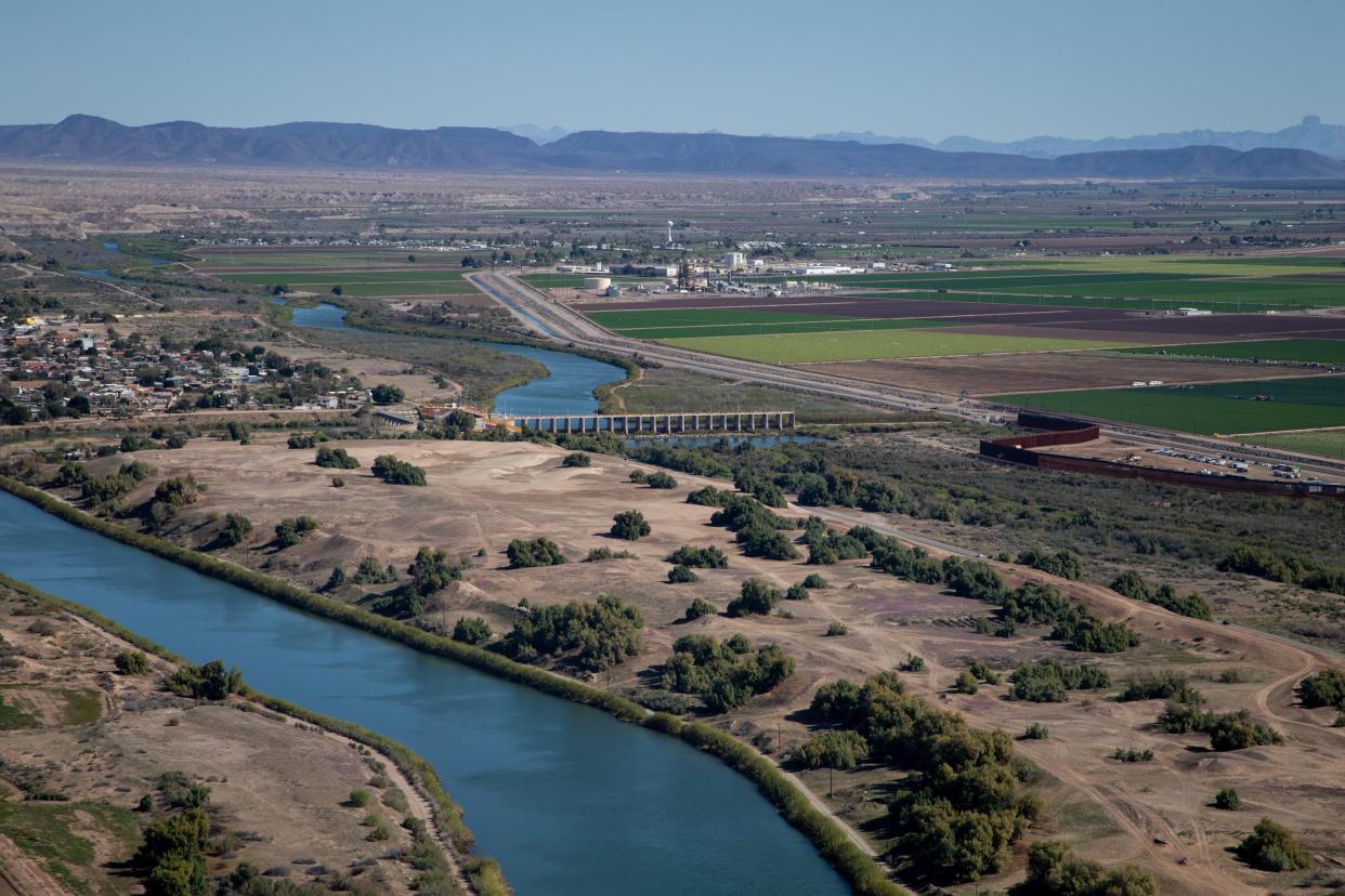 The Colorado River (top center) flows up to Morelos Dam on the U.S.-Mexico border. The Colorado River channel then continues next to the border wall (right center). This area has become a frequent crossing point for migrants seeking to enter the United States from Mexico.