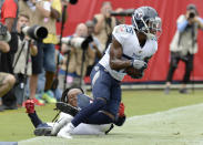 Tennessee Titans cornerback Adoree' Jackson (25) intercepts a pass intended for Houston Texans wide receiver DeAndre Hopkins, on the ground, in the end zone during the first half of an NFL football game Sunday, Sept. 16, 2018, in Nashville, Tenn. (AP Photo/Mark Zaleski)