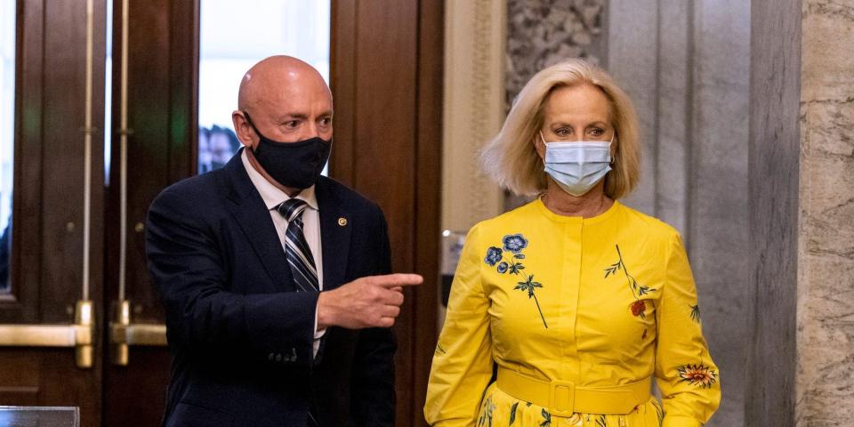 Democratic Sen. Mark Kelly of Arizona walks with Cindy McCain, the wife of the late Sen. John McCain and the current US Ambasssador to the United Nations Agencies for Food and Agriculture, at the Capitol on August 4, 2021.
