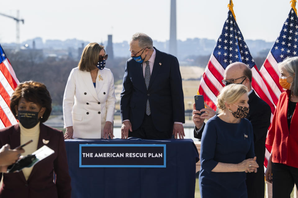 UNITED STATES - MARCH 10: From left, Rep. Maxine Waters, D-Calif., Speaker of the House Nancy Pelosi, D-Calif., Senate Majority Leader Chuck Schumer, D-N.Y., Reps. Carolyn Maloney, D-N.Y., Jim McGovern, D-Mass., and Katherine Clark, D-Mass., attend a bill enrollment ceremony for the American Rescue Plan Act on the West Front of the Capitol after the House passed the $1.9 trillion covid-19 relief package on Wednesday, March 10, 2021. (Photo By Tom Williams/CQ-Roll Call, Inc via Getty Images)