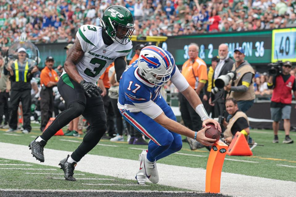 Buffalo Bills quarterback Josh Allen (17) carries the ball for a rushing touchdown against New York Jets safety Jordan Whitehead (3) during the first half Sunday.