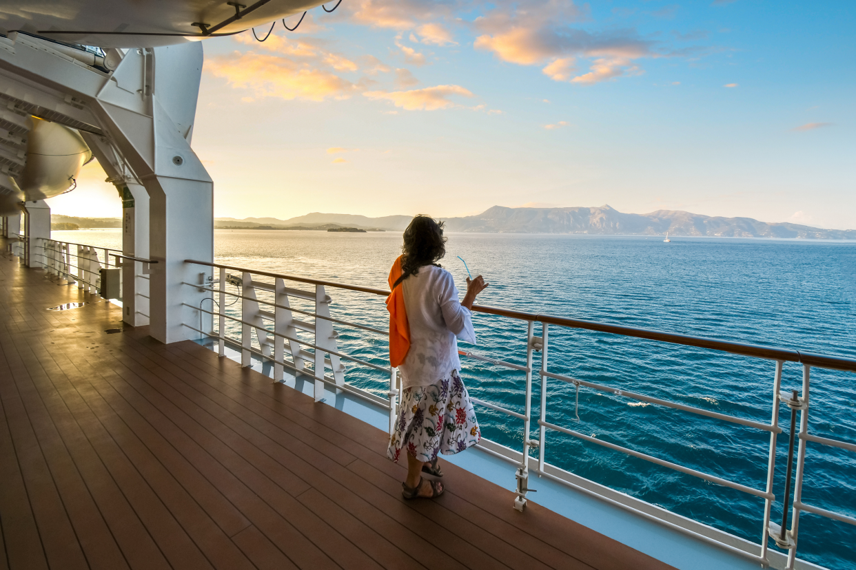 Lone Woman on Board Cruise Ship With Drink Enjoying Sunset in the Aegean Sea