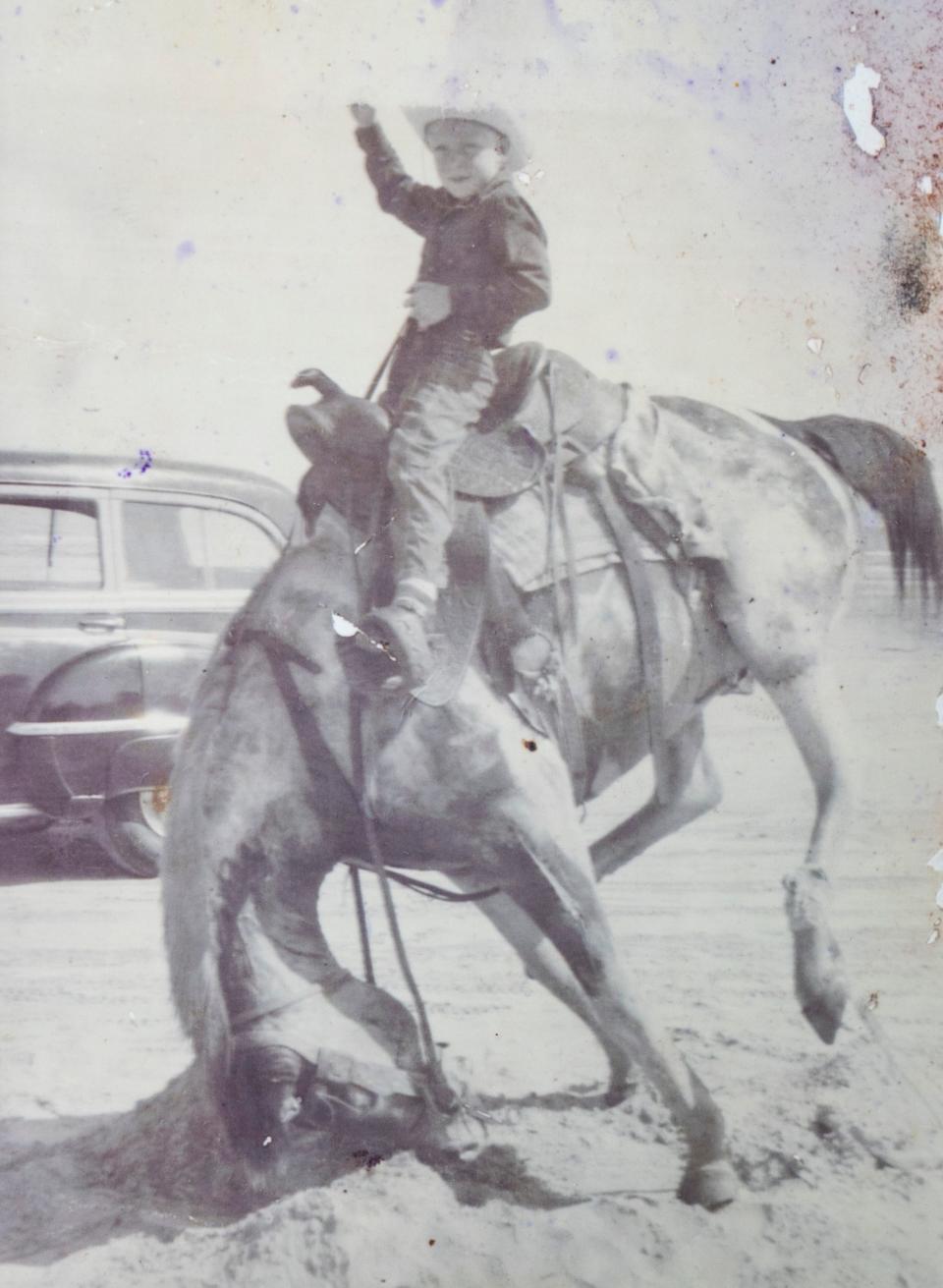 Pat Beall's brother on a bucking bronco.