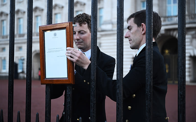 An official statement confirming the death of Queen Elizabeth II is posted in front of Buckingham Palace