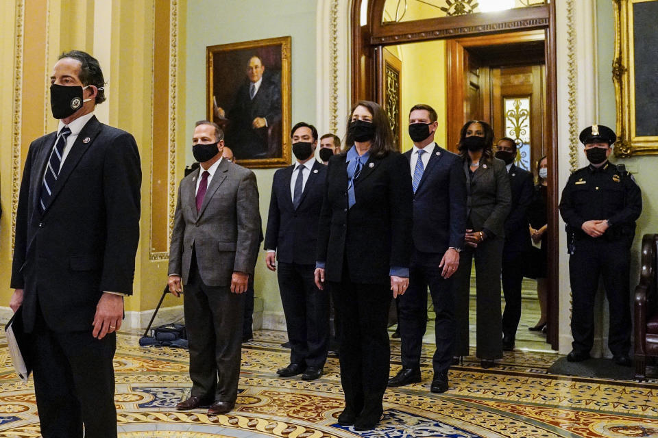 FILE - In this Jan. 25, 2021, file photo Democratic House impeachment managers stand after delivering the article of impeachment to the Senate alleging incitement of insurrection against former President Donald Trump, in Washington. From left, Rep. Jamie Raskin, D-Md., Rep. David Cicilline, D-R.I., Rep. Joaquin Castro, D-Texas, Rep. Diana DeGette, D-Colo., Rep. Eric Swalwell, D-Calif., Del. Stacey Plaskett, D-Virgin Islands, and Rep. Joe Neguse, D-Colo. (Melina Mara/The Washington Post via AP, Pool, File)