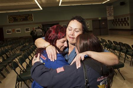 (L - R) Gabrielle Rogano, Hazel Powers, and Rachel Sarzynski embrace after hearing the results of a union vote at the International Association of Machinists District 751 Headquarters in Seattle, Washington November 13, 2013. REUTERS/David Ryder