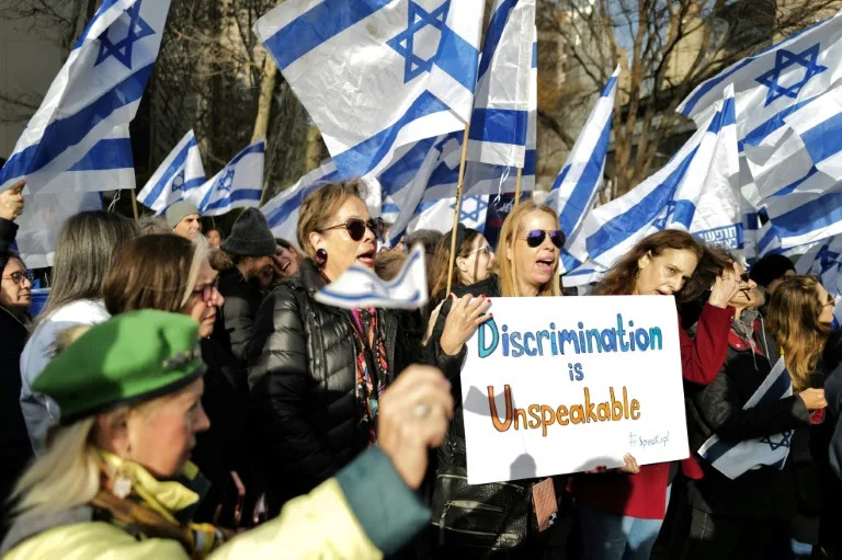 Under the slogan 'Me too, unless you're a Jew', the protesters chanted 'shame on UN', sported banners reading 'rape is rape' (Charly TRIBALLEAU)