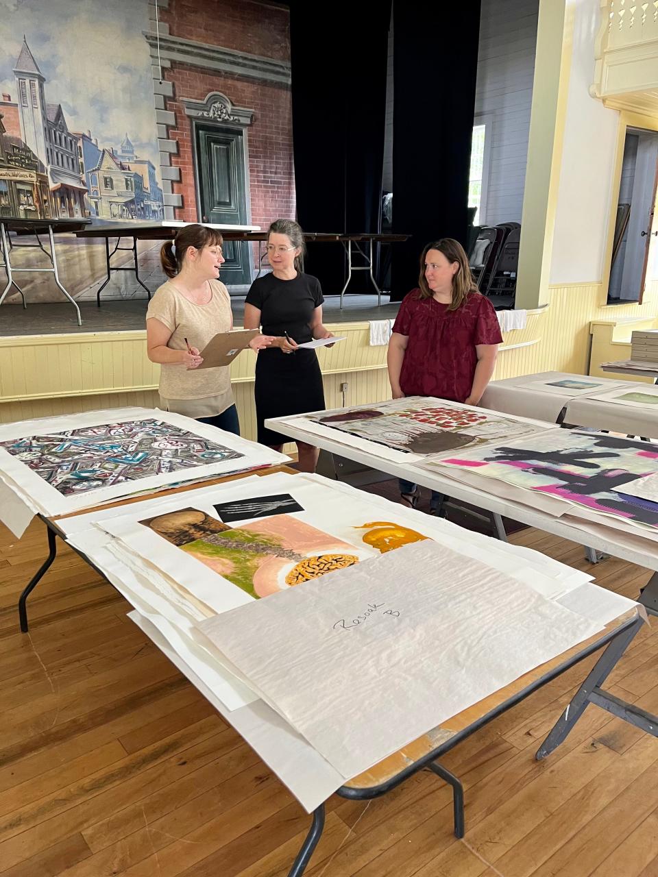 Carolyn Frisa, a paper conservator advisory board member with VACDaRN leads a workshop for artists and volunteers at Vermont Studio Center to teach them how to safely rinse and dry a print collection damaged but flood waters.