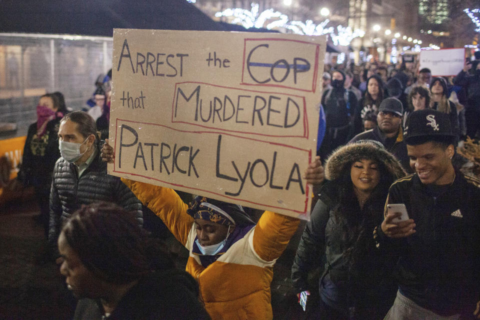 Protesters march through downtown Grand Rapids, Mich., near the police department during a demonstration held after videos of the shooting of Patrick Lyoya, by a Grand Rapids police officer from April 4, were released to the public on Wednesday, April 13, 2020. (Daniel Shular/The Grand Rapids Press via AP)