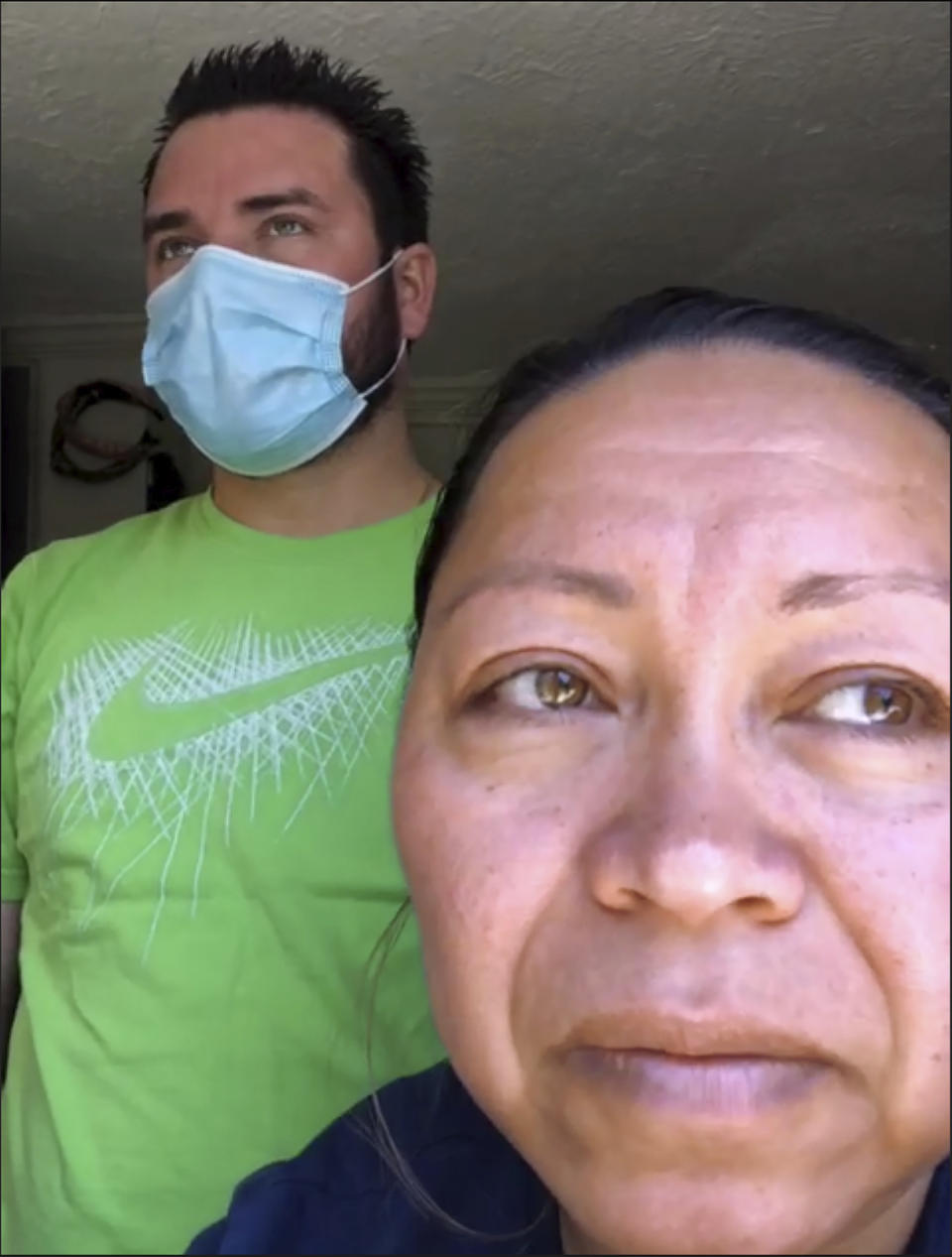 Screen grab shows a portrait from a Zoom interview with Roberto, left, and Janeth, who have both tested positive for COVID-19, Wednesday, May 13, 2020, in Washington. Janeth and her husband Roberto, as well as her sister Arely in Baltimore, have all been diagnosed with COVID-19. (AP Photo/Jacquelyn Martin)