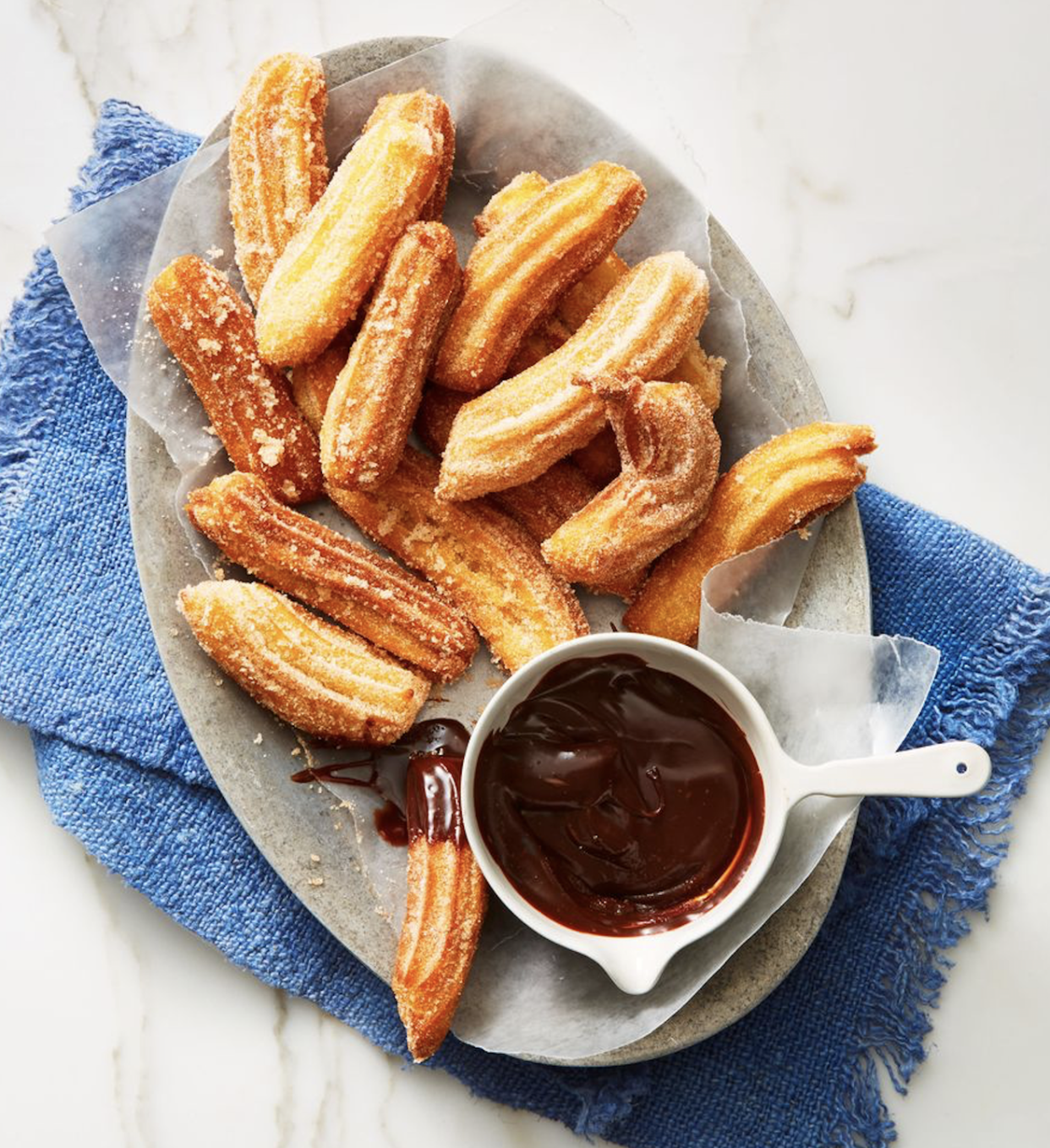 cinnamon churros with chocolate dipping sauce on the side