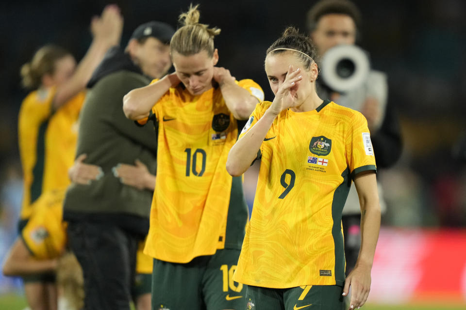 Australia's Caitlin Foord, right, and Emily Van Egmond react after their loss during the Women's World Cup semifinal soccer match between Australia and England at Stadium Australia in Sydney, Australia, Wednesday, Aug. 16, 2023. (AP Photo/Rick Rycroft)