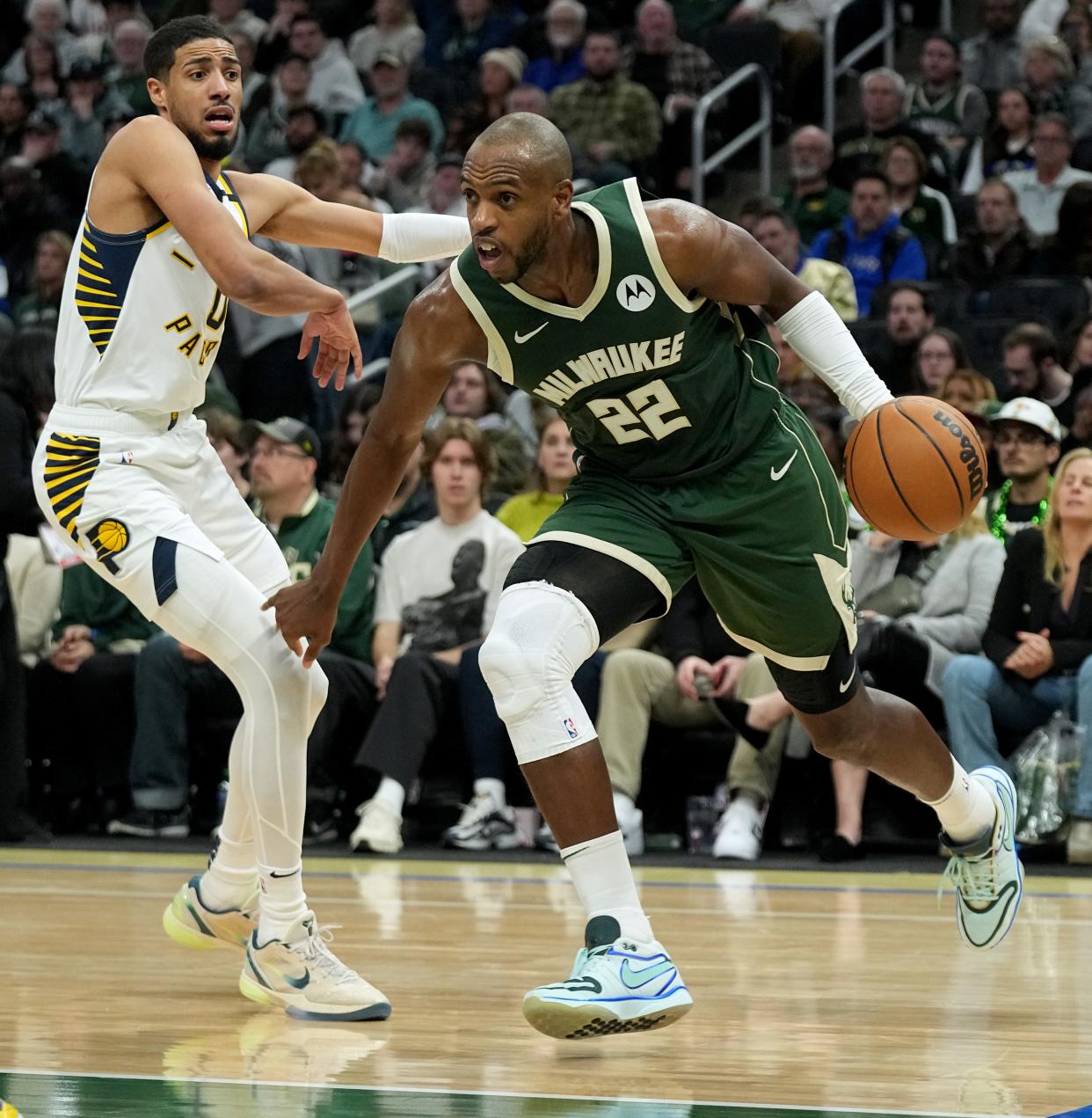 Milwaukee Bucks forward Khris Middleton (22) turns the corner on Indiana Pacers guard Tyrese Haliburton (0) during the second half of their game Monday, January 1, 2024 at Fiserv Forum in Milwaukee, Wisconsin. The Indiana Pacers beat the Milwaukee Bucks 122-113.