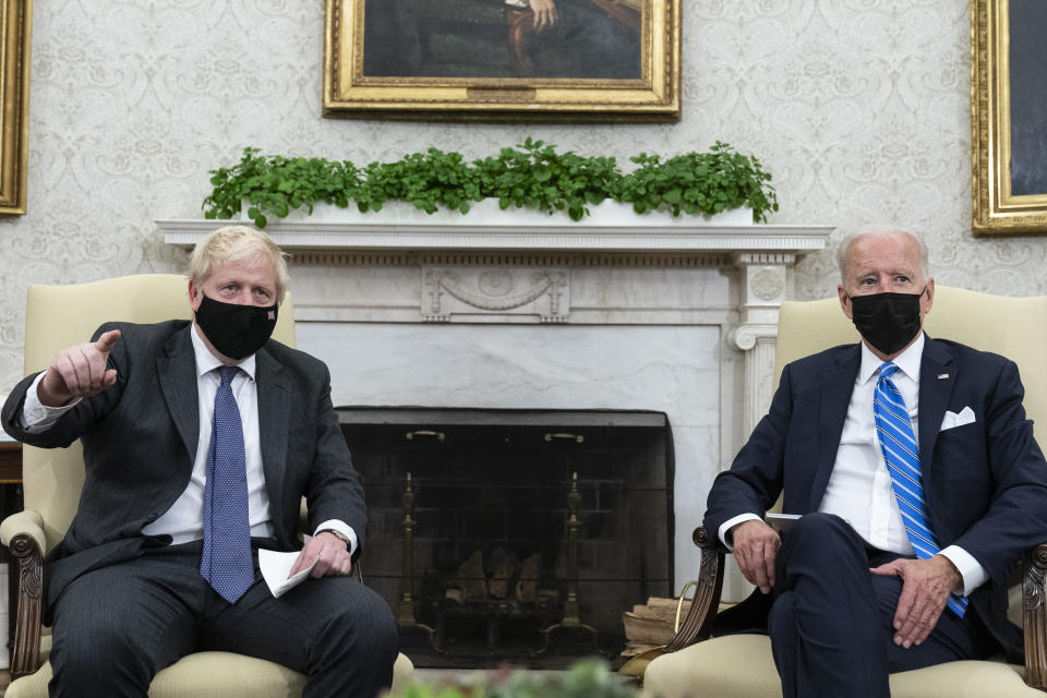 President Joe Biden, right, listens as British Prime Minister Boris Johnson speaks during a meeting in the Oval Office of the White House, Tuesday, Sept. 21, 2021, in Washington. (AP Photo/Alex Brandon)