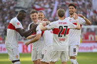 Stuttgart's scorer Deniz Undav (26) and his teammates celebrate their side's second goal during the German Bundesliga soccer match between VfB Stuttgart and Eintracht Frankfurt in Stuttgart, Germany, Saturday, April 13, 2024. (Jan-Philipp Strobel/dpa via AP)