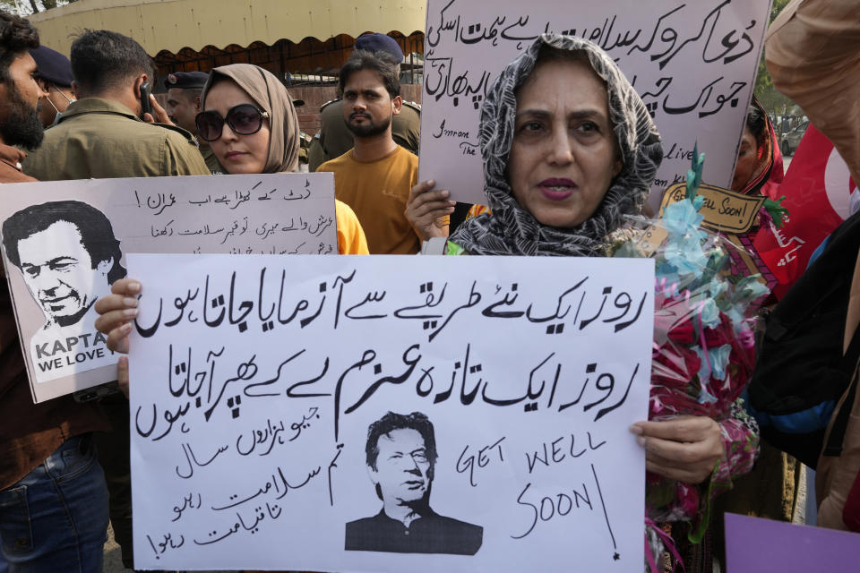 Supporters of former Pakistani Prime Minister Imran Khan's party, Pakistan Tehreek-e-Insaf hold a demonstration to condemn a shooting incident on their leader's convoy, in Lahore, Pakistan, Friday, Nov. 4, 2022. Khan who narrowly escaped an assassination attempt on his life the previous day when a gunman fired multiple shots and wounded him in the leg during a protest rally is listed in stable condition after undergoing surgery at a hospital, a senior leader from his party said Friday. (AP Photo/K.M. Chaudhry)