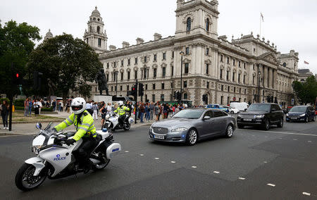Police outriders accompany the British Prime Minister Theresa May's official car as it arrives at the House of Parliament in London, Britain, June 20, 2018. REUTERS/Henry Nicholls