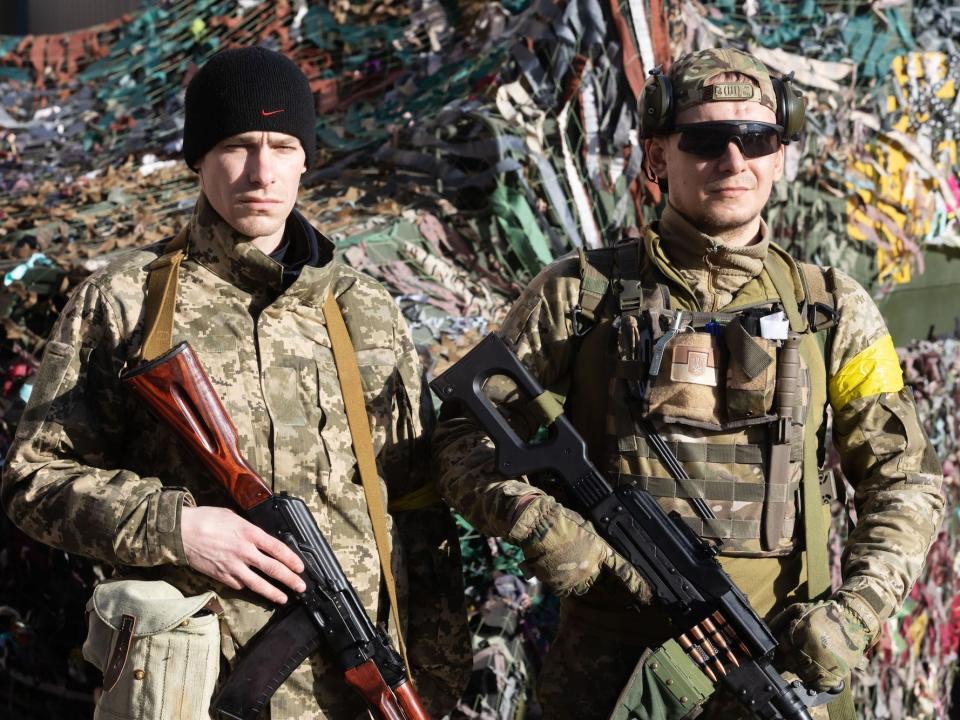 Members of Kyiv defense battalion seen holding their rifles.