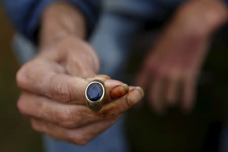 Lantz Rowland, 59, holds a ring as he poses in front of his tent at SHARE/WHEEL Tent City 3 outside Seattle, Washington October 8, 2015. REUTERS/Shannon Stapleton