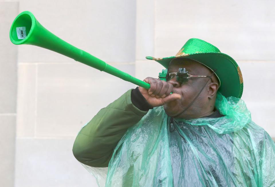 An Akron street vendor touts his merchandise during the St. Patrick's Day Parade in downtown Akron March 9. Various other holiday events will be happening in the city this upcoming weekend.