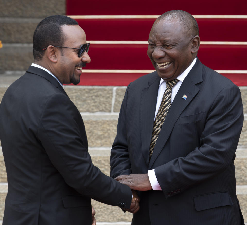 South African President Cyril Ramaphosa, right, welcomes Ethiopia's Prime Minister Abiy Ahmed prior to their talks at the Union Building in Pretoria, South Africa, Sunday, Jan. 12, 2020. (AP Photo/Themba Hadebe)