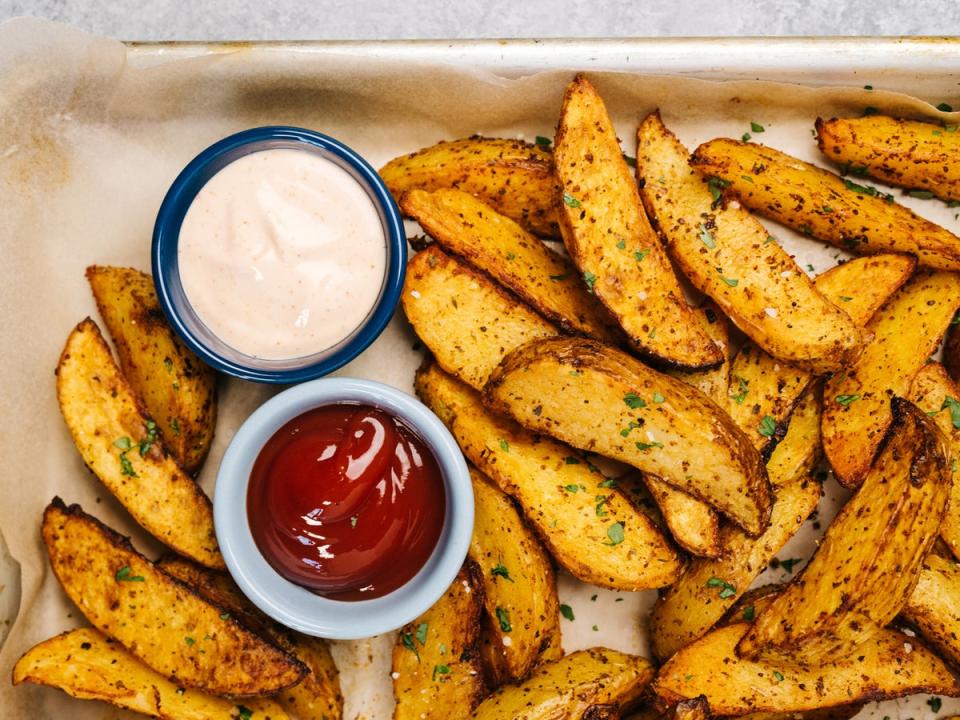 Golden and crispy potato wedges seasoned to perfection, straight from the air fryer (Getty)