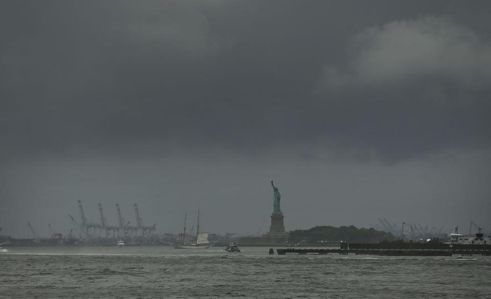 The Statue of Liberty stands in New York Harbor on a rainy and windy afternoon July 25, 2018, in New York.  After weeks of sunshine and warmth, New York City and much of the East Coast experienced a rainy week with forecasts of potential flash flooding, high winds and thunderstorms, according to the National Weather Service.