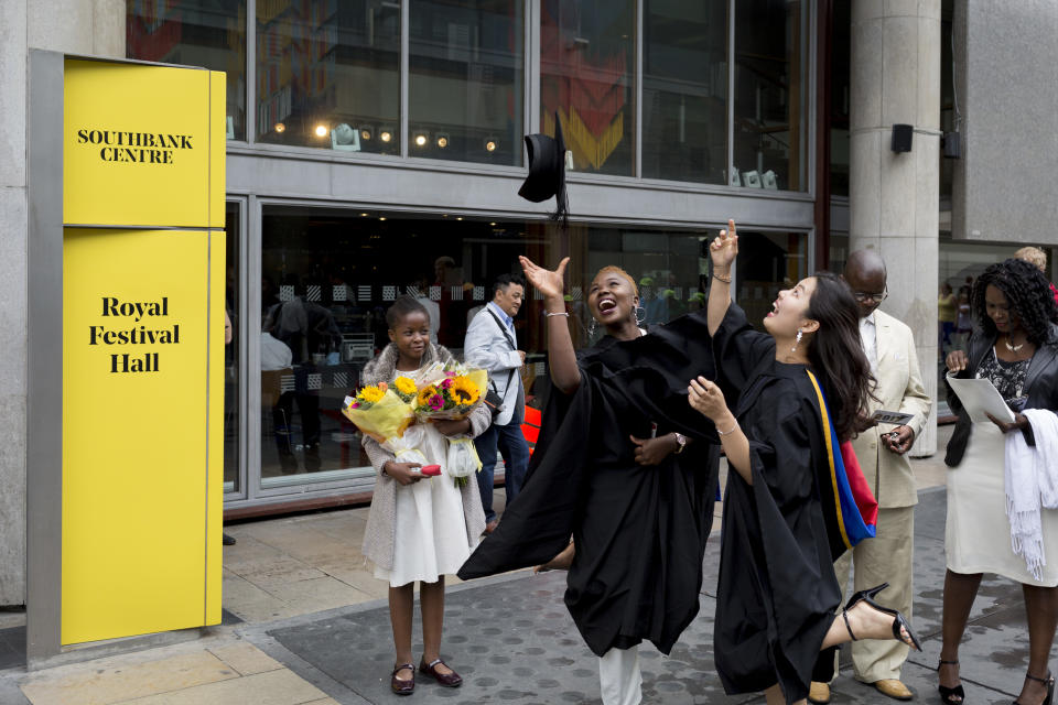 Graduates fling their rented mortarboard hats into the air after their graduation ceremony. Photo: Richard Baker / In Pictures for Getty Images