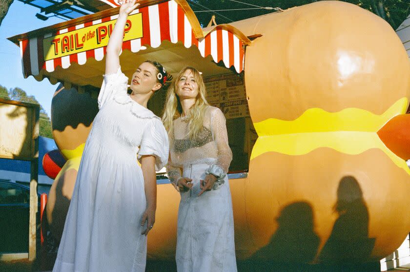 WEST HOLLYWOOD, CA - AUGUST 27TH, 2022: Rhian Teasdale (left) and Hester Chambers (right) of the indie rock duo Wet Leg outside Tail o' the Pup Hot Dog Stand in West Hollywood, California. (CREDIT: Caity Krone/For The Times)