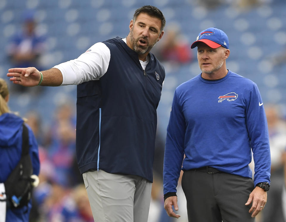 FILE - In this Sunday, Oct. 7, 2018, file photo, Tennessee Titans head coach Mike Vrabel, left, talks to Buffalo Bills head coach Sean McDermott prior to an NFL football game, in Orchard Park, N.Y. The NFL's ranks of undefeated teams should thin by one Tuesday night, Oct. 13, 2020, when the Buffalo Bills and Tennessee Titans finally meet in a rescheduled game. (AP Photo/Adrian Kraus, File)