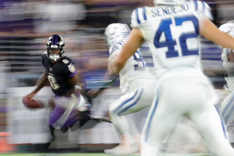 Baltimore Ravens quarterback Lamar Jackson (8) runs with the ball as Indianapolis Colts defensive tackle DeForest Buckner (99) chases during the fourth quarter at M&T Bank Stadium.