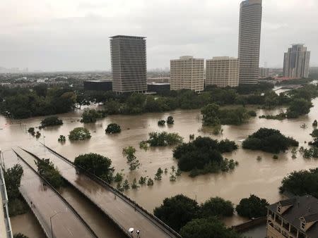Flooded downtown is seen from a high rise along Buffalo Bayou after Hurricane Harvey inundated the Texas Gulf coast with rain causing widespread flooding, in Houston, Texas, U.S. August 27, 2017 in this picture obtained from social media. Mandatory credit: Twitter/@caroleenarn via REUTERS