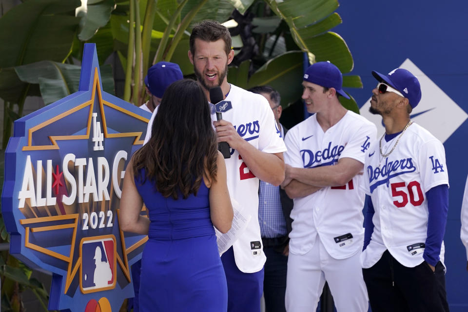 Los Angeles Dodgers' Clayton Kershaw, second from left, speaks with Alanna Rizzo, left, of the MLB Network as Walker Buehler, second from right, and Mookie Betts look on during an event to officially launch the countdown to MLB All-Star Week Tuesday, May 3, 2022, at Dodger Stadium in Los Angeles. The All-Star Game is scheduled to be played on July 19. (AP Photo/Mark J. Terrill)