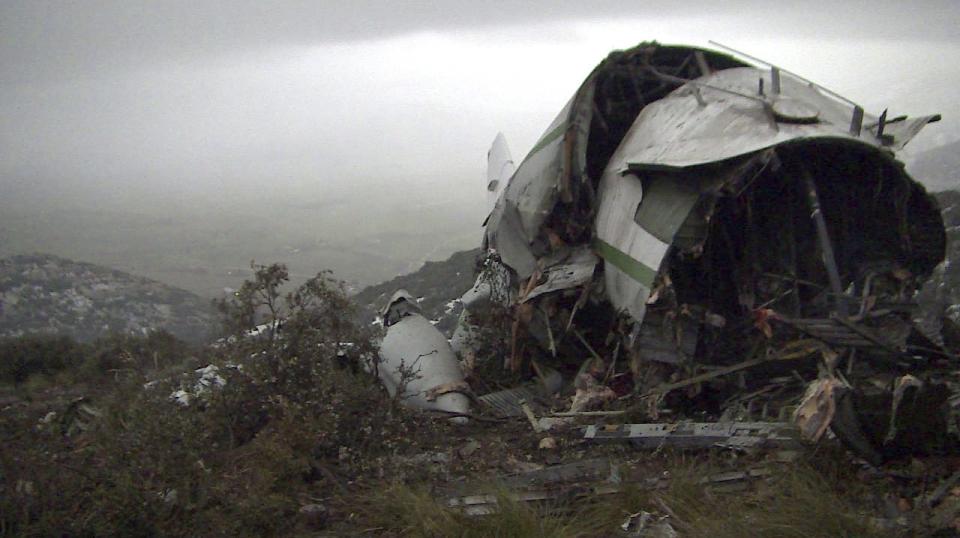 The wreckage of an Algerian military transport plane which slammed into a mountain Tuesday in the country's rugged eastern region, is pictured Wednesday, Feb. 12, 2014. The crash killed scores of people and left just one survivor, the defense ministry said. The plane was discovered in pieces on Mount Fortas near the town of Ain Kercha, 50 kilometers (30 miles) southeast of Constantine, the main city in eastern Algeria. (AP Photo/Anis Belghoul)